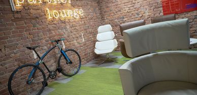 Ein Raum mit Sessel und Fahrrad. 